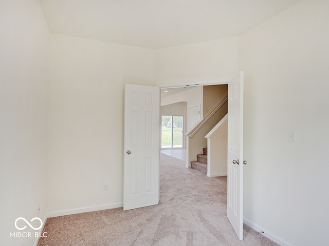 unfurnished room featuring light colored carpet