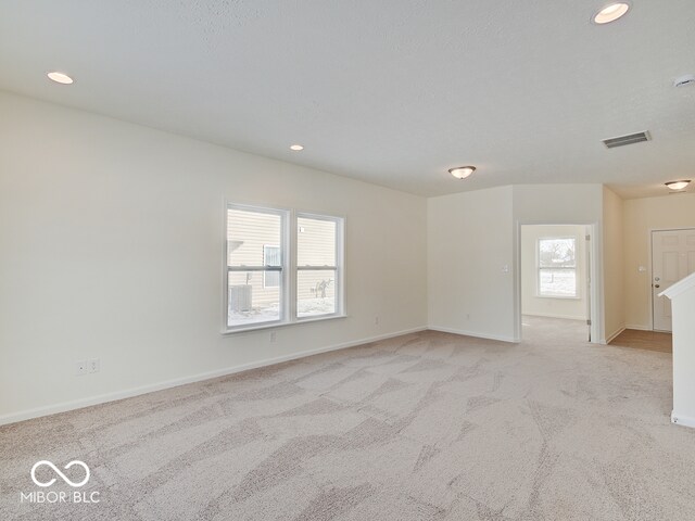 unfurnished room featuring recessed lighting, visible vents, light carpet, and baseboards