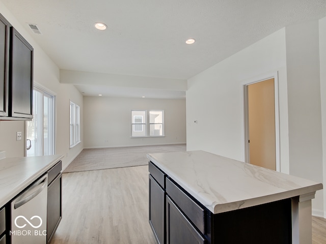 kitchen with light wood-style flooring, light stone counters, open floor plan, stainless steel dishwasher, and recessed lighting