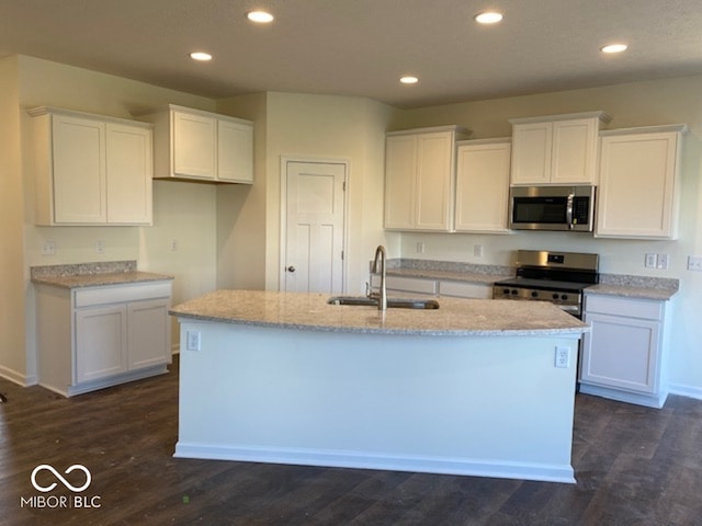 kitchen featuring stainless steel appliances, white cabinetry, and sink