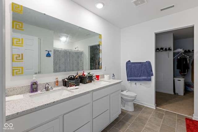 bathroom featuring vanity, toilet, and a shower with shower curtain