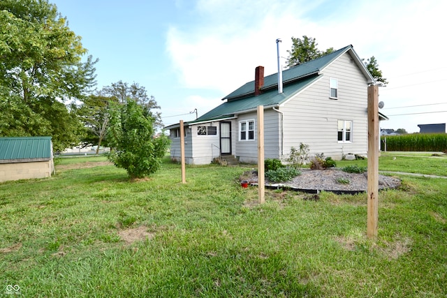 back of property featuring a lawn