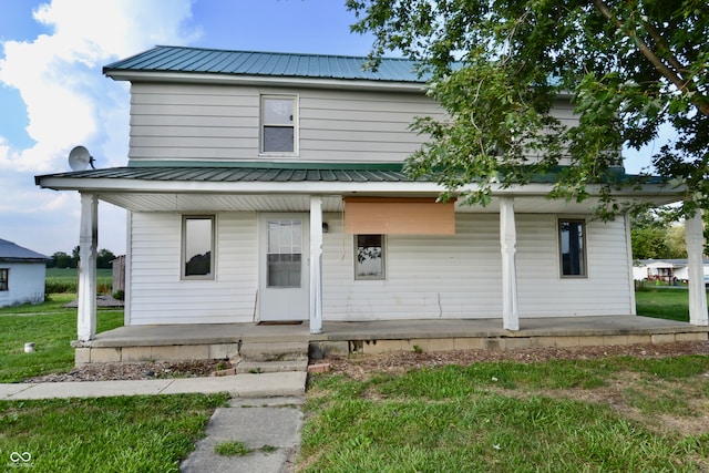 view of front of property with a front yard and a porch