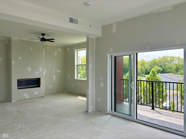 unfurnished living room featuring a ceiling fan, visible vents, and concrete floors