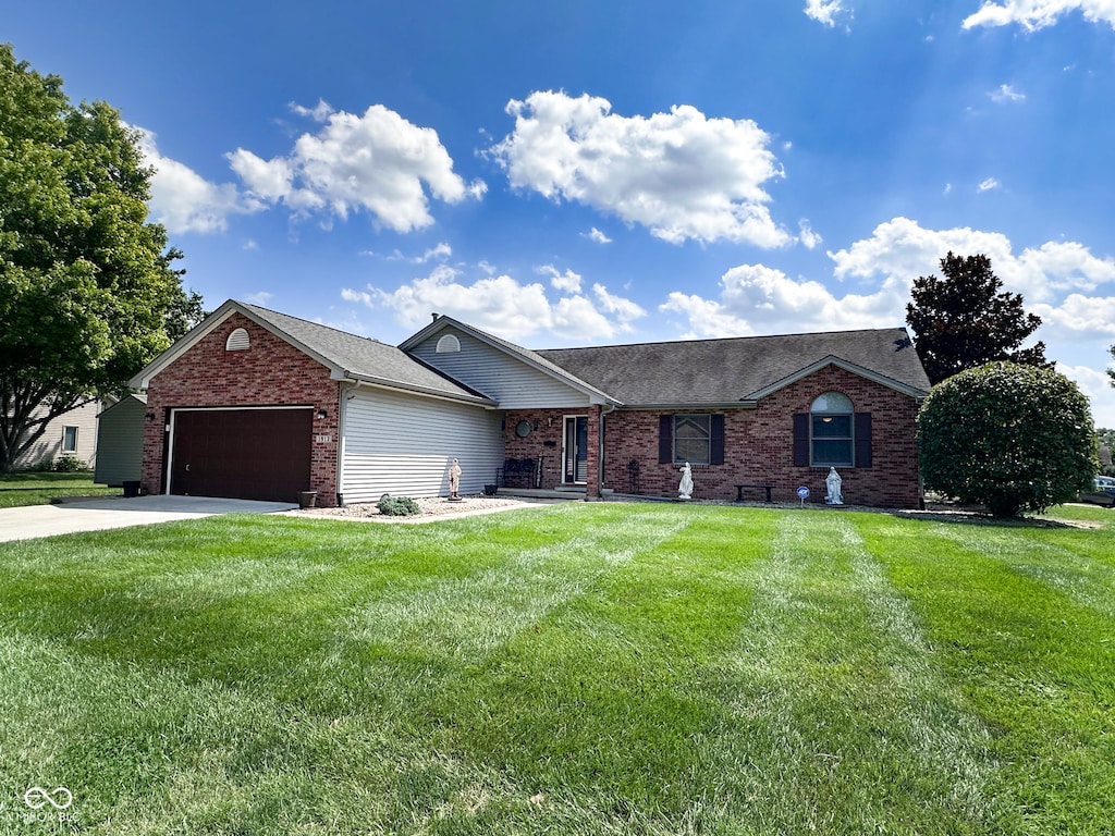 ranch-style house with a garage and a front lawn