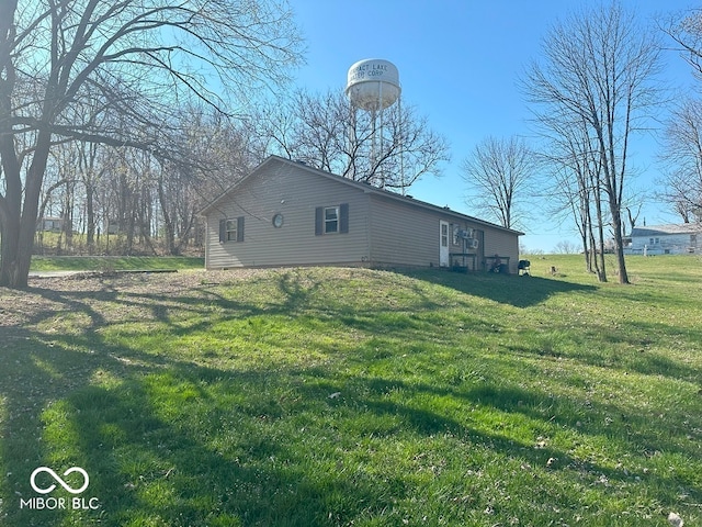 view of side of home featuring a yard