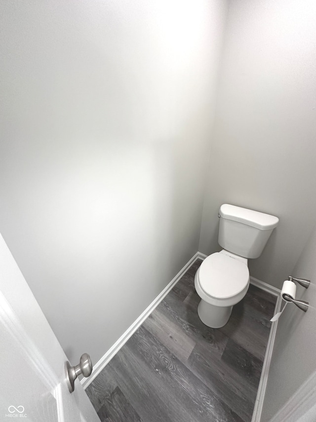 bathroom featuring toilet and wood-type flooring