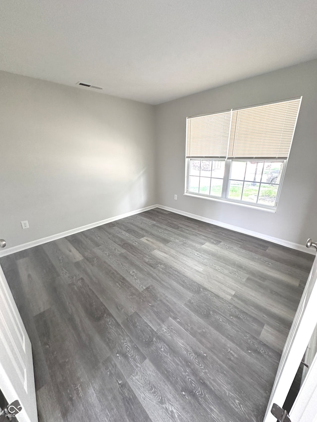 spare room with hardwood / wood-style floors