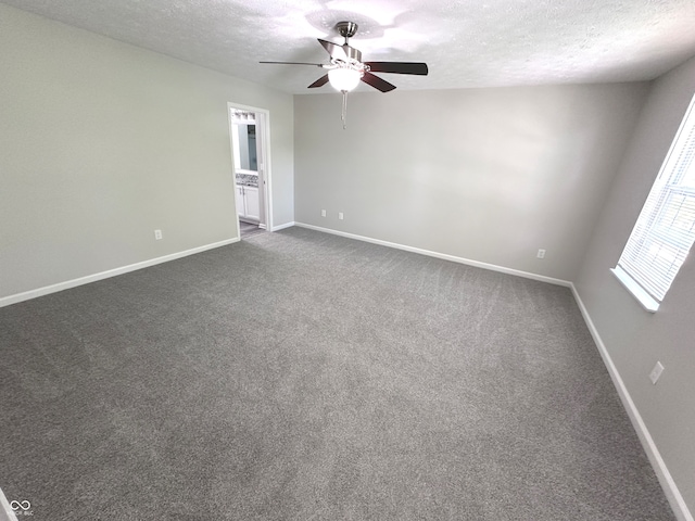 carpeted empty room with ceiling fan and a textured ceiling