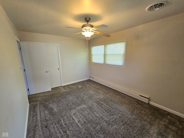 unfurnished bedroom featuring dark colored carpet, a closet, ceiling fan, and baseboard heating