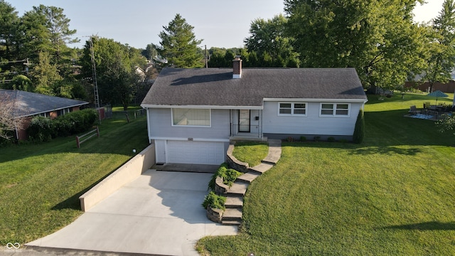 view of front facade with a garage and a front lawn