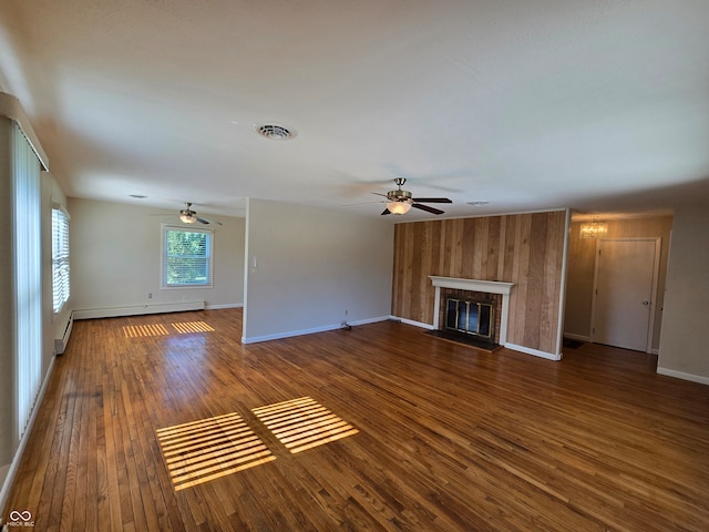 unfurnished living room with ceiling fan, baseboard heating, and dark hardwood / wood-style floors