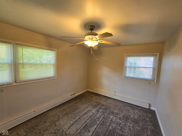 spare room featuring ceiling fan, a baseboard heating unit, and dark colored carpet