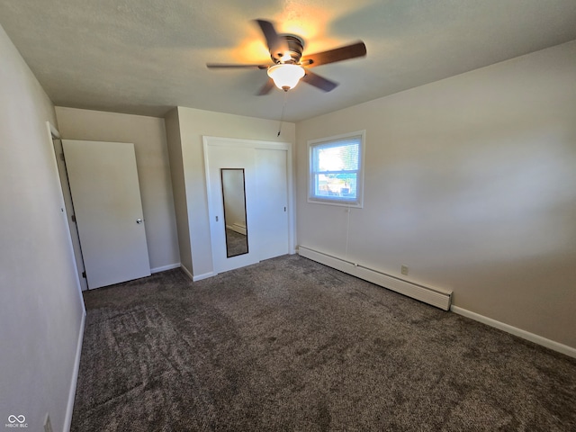 unfurnished bedroom with ceiling fan, a closet, carpet, and baseboard heating