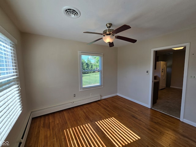 spare room with dark hardwood / wood-style flooring and ceiling fan