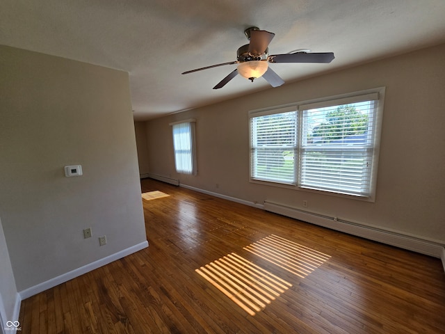 empty room with ceiling fan, a baseboard heating unit, and wood-type flooring