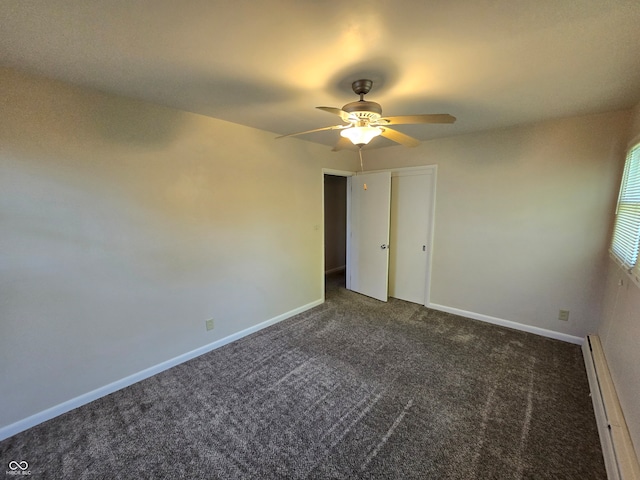 unfurnished bedroom with ceiling fan, carpet, and baseboard heating