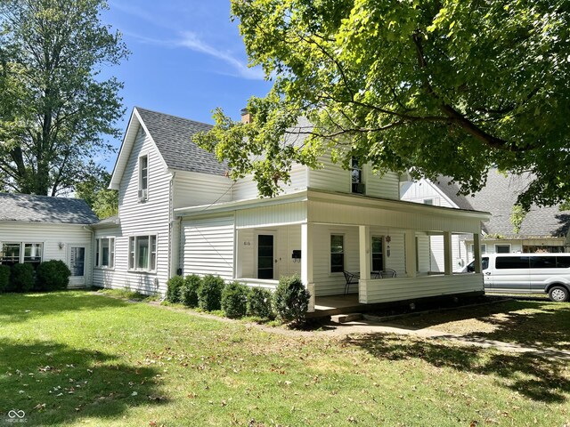 back of property featuring a lawn