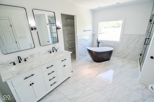 bathroom featuring vanity, independent shower and bath, tile patterned floors, and tile walls