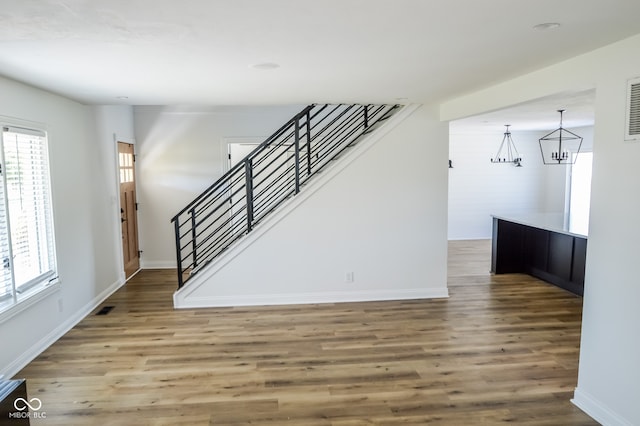 interior space with an inviting chandelier and hardwood / wood-style flooring