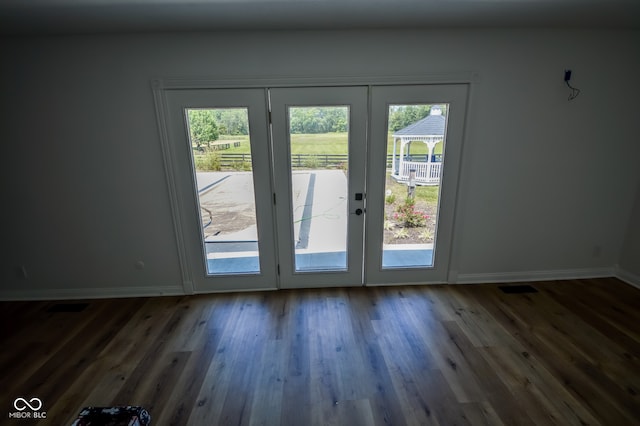 doorway to outside with plenty of natural light, french doors, and hardwood / wood-style floors