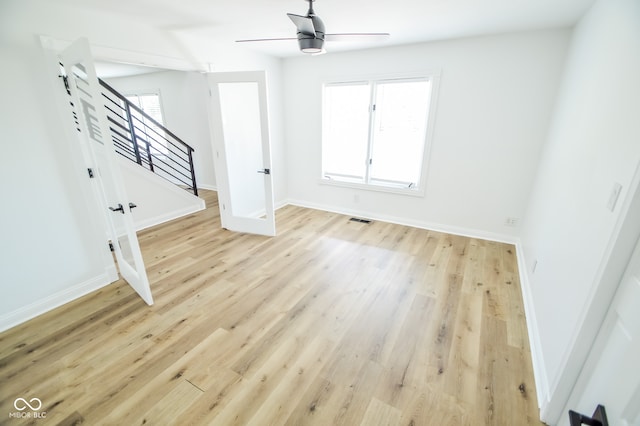 unfurnished living room featuring ceiling fan and light hardwood / wood-style floors