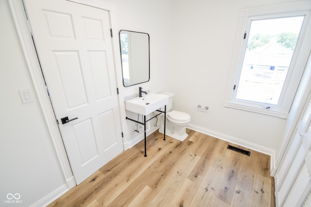 bathroom featuring hardwood / wood-style flooring, sink, and toilet