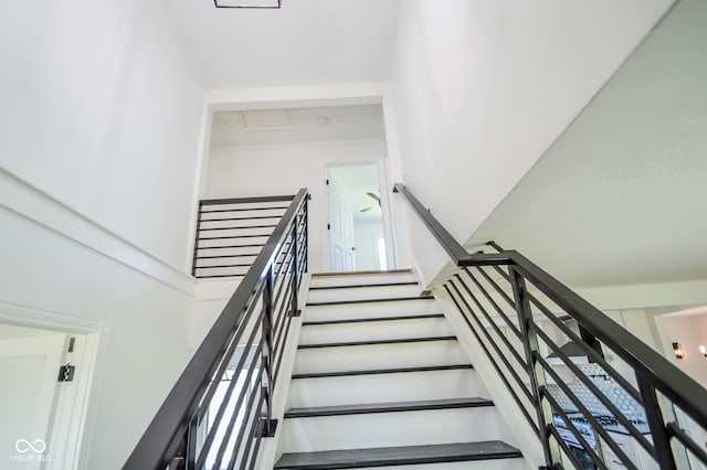 staircase with a high ceiling