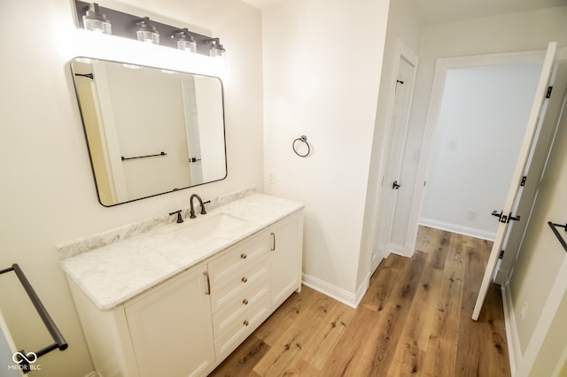 bathroom with hardwood / wood-style flooring and vanity