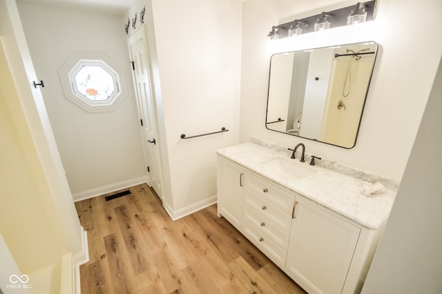 bathroom featuring hardwood / wood-style flooring and vanity