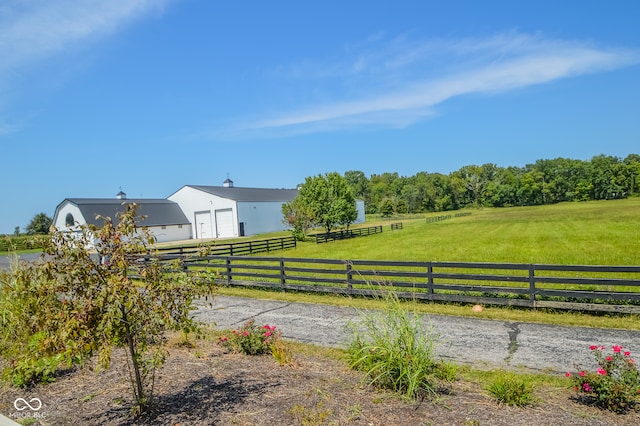 view of yard with a rural view and an outbuilding