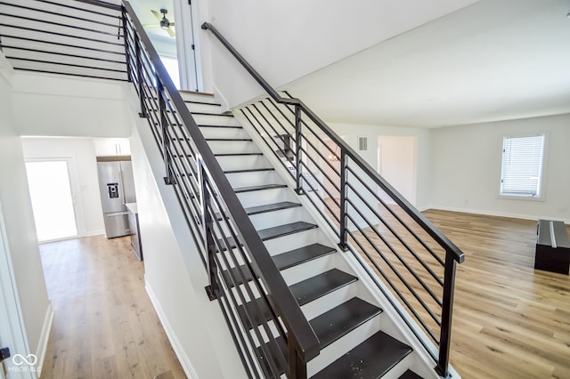 staircase with hardwood / wood-style flooring