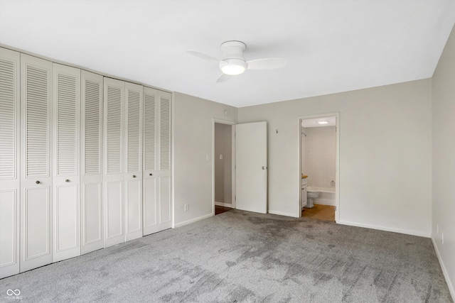 unfurnished bedroom with ceiling fan, connected bathroom, a closet, and light carpet