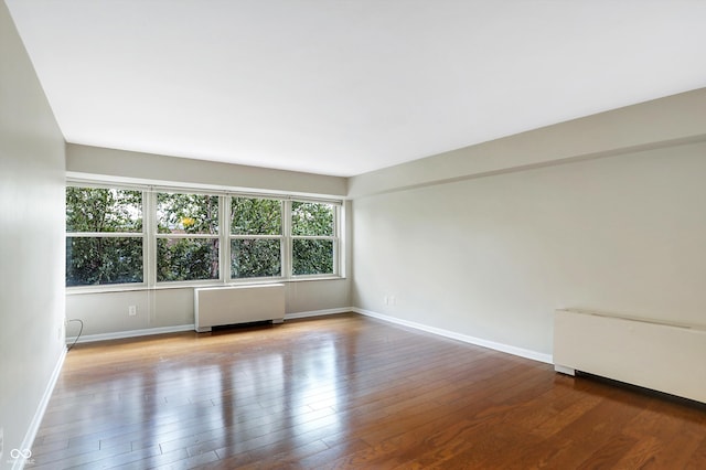 empty room with radiator and wood-type flooring