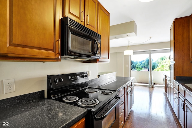 kitchen featuring dark hardwood / wood-style floors and black appliances