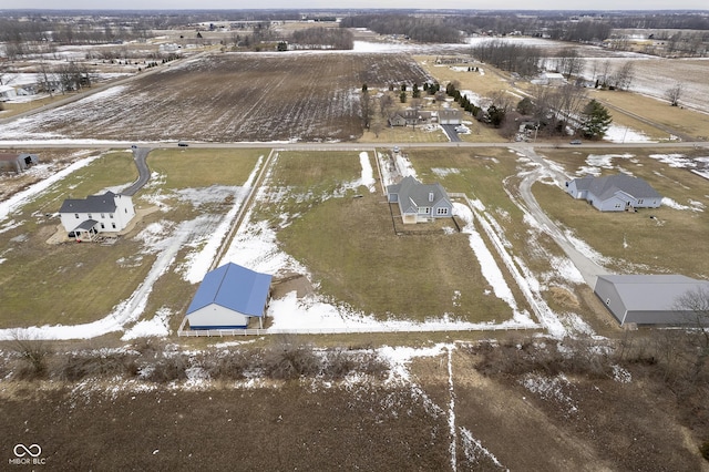 snowy aerial view featuring a rural view