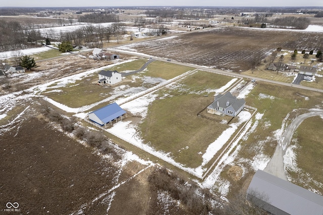 snowy aerial view featuring a rural view