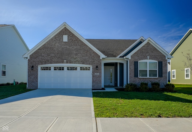 view of front of property with a garage and a front lawn