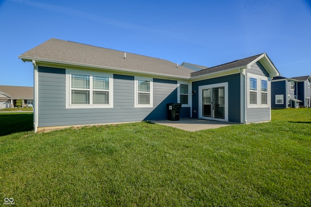 back of property with a patio and a lawn