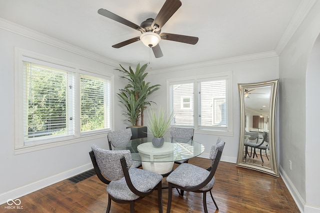 dining room with ornamental molding, dark wood-type flooring, and ceiling fan