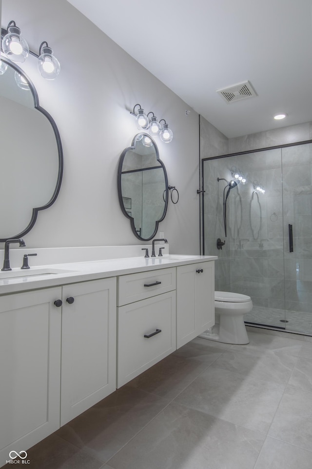 bathroom with toilet, double vanity, an enclosed shower, and tile patterned floors