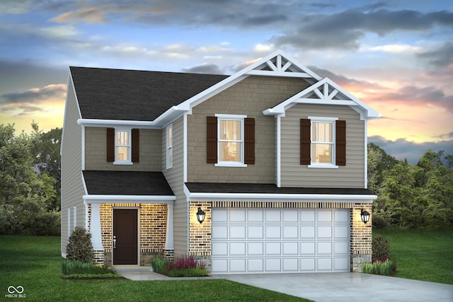 view of front of property featuring a lawn and a garage