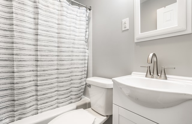 full bathroom featuring vanity, shower / tub combo with curtain, and toilet