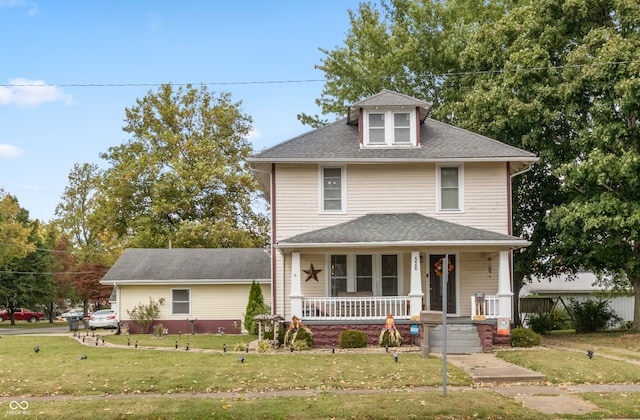 view of front of home with a front yard and a porch