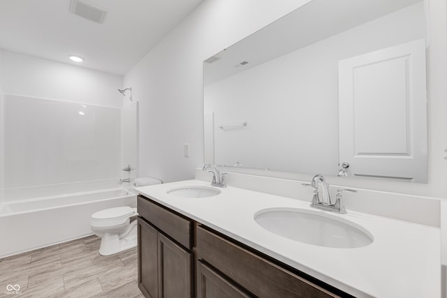 bathroom featuring double vanity, visible vents, a sink, and shower / bathing tub combination