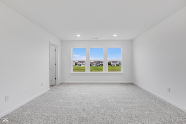 unfurnished room featuring recessed lighting, visible vents, baseboards, and light colored carpet