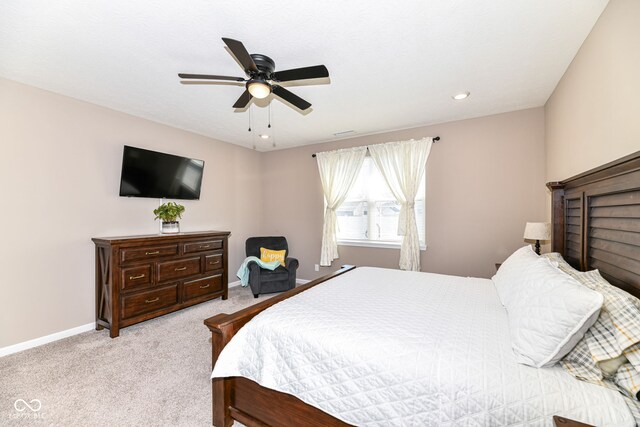 bedroom featuring ceiling fan and light colored carpet