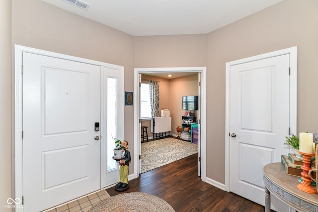 foyer entrance with dark hardwood / wood-style floors