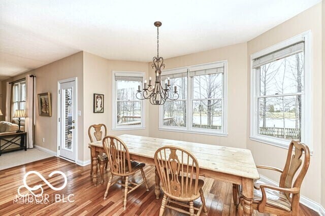 14626 Warner Trl, Westfield, IN 46074 - dining space featuring wood finished floors, baseboards, and a chandelier