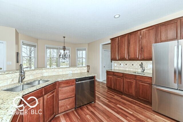 14626 Warner Trl, Westfield, IN 46074 - kitchen with stainless steel appliances, a sink, dark wood-style flooring, backsplash, and recessed lighting
